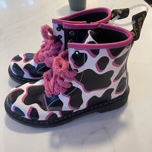 Dr. Martens Kids 1460 cow print patent leather boots in black, white, and pink